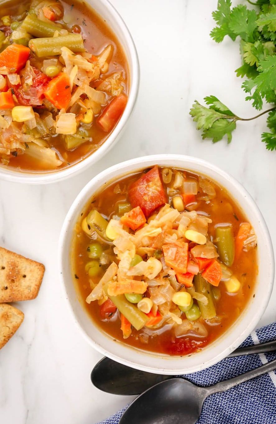 Healthy vegetable soup with cabbage, corn, green beans, tomatoes, and more. 