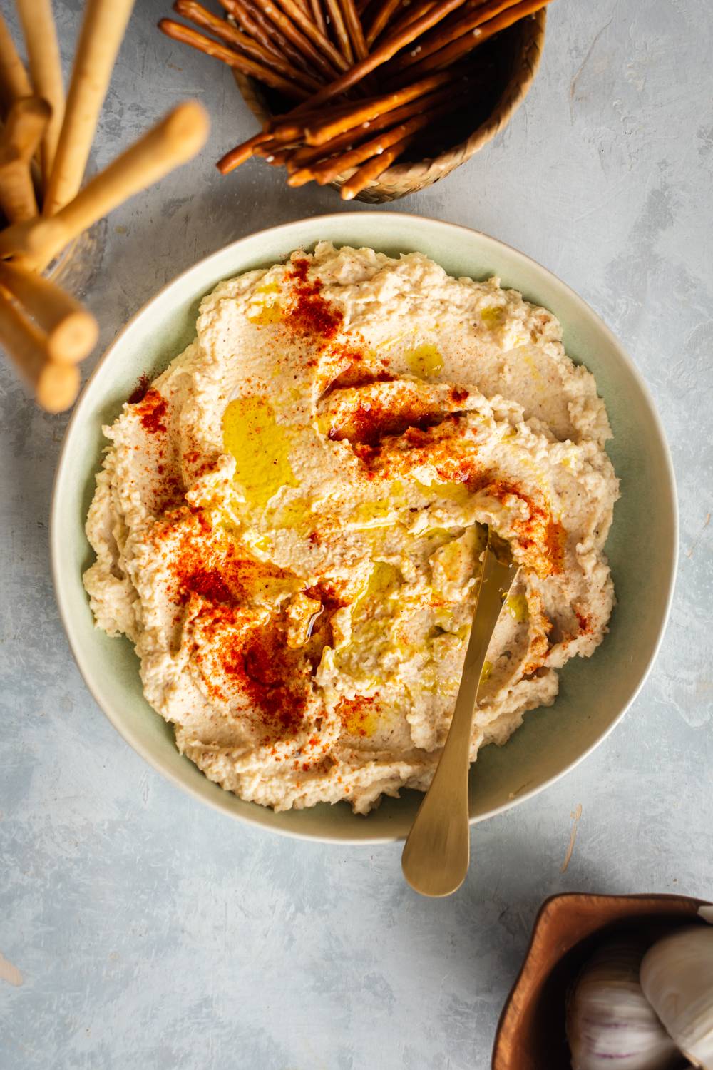 Keto cauliflower hummus served in a bowl made with roasted cauliflower, tahini, lemon, and garlic.