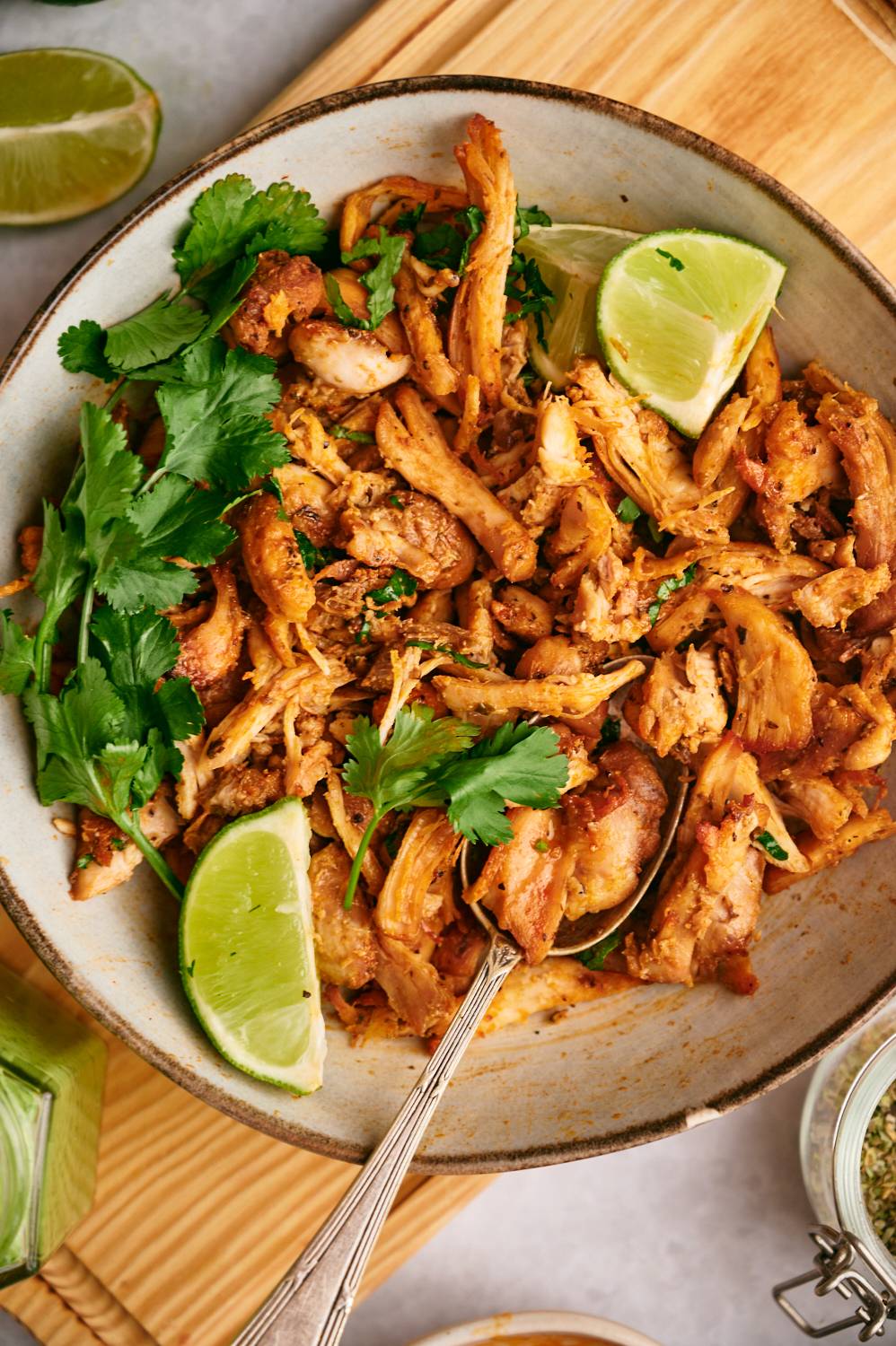 Slow cooker Chicken Carnitas with lime juice and pico de gallo.