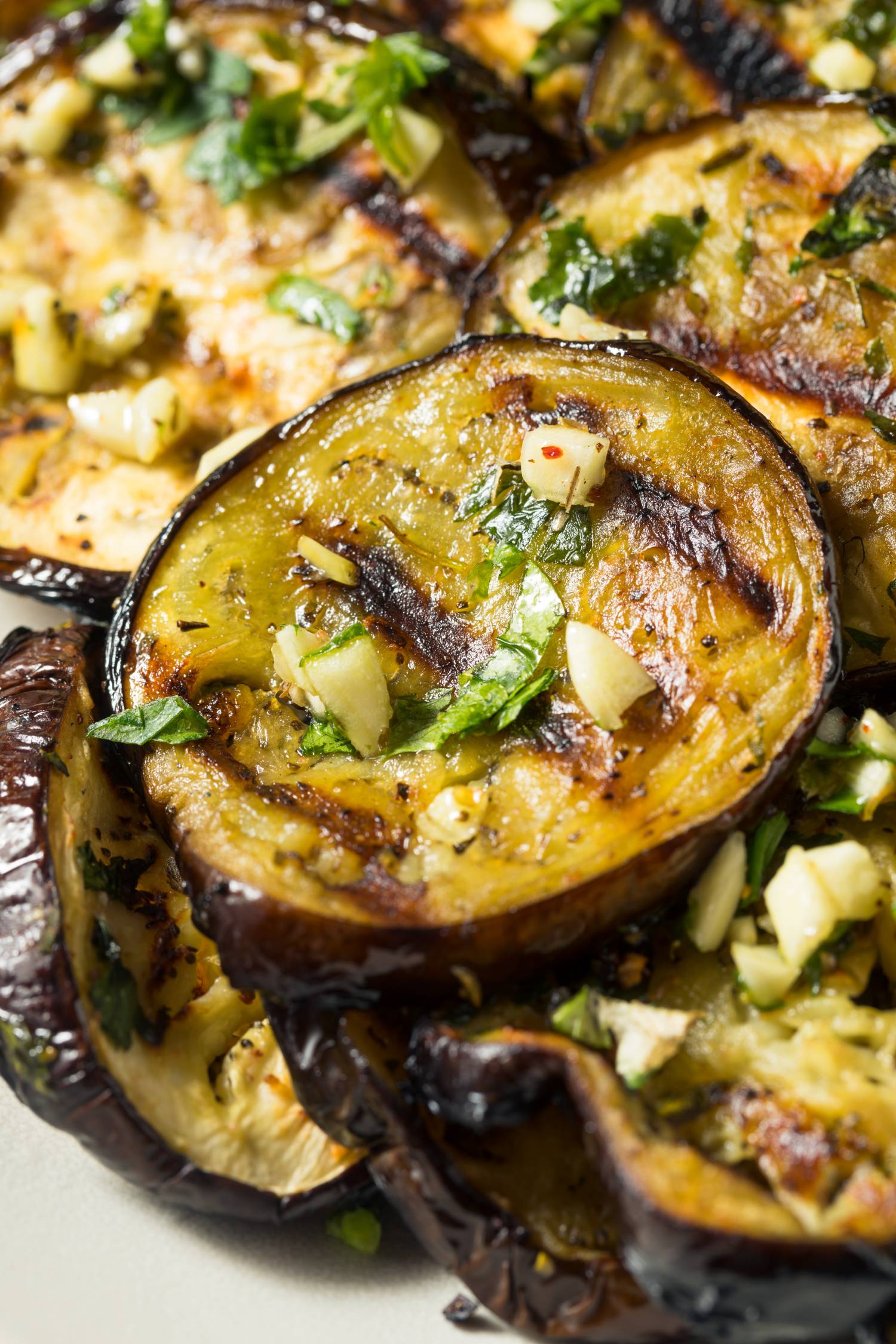 Grilled eggplant slices with parsley, garlic, and balsamic marinade.