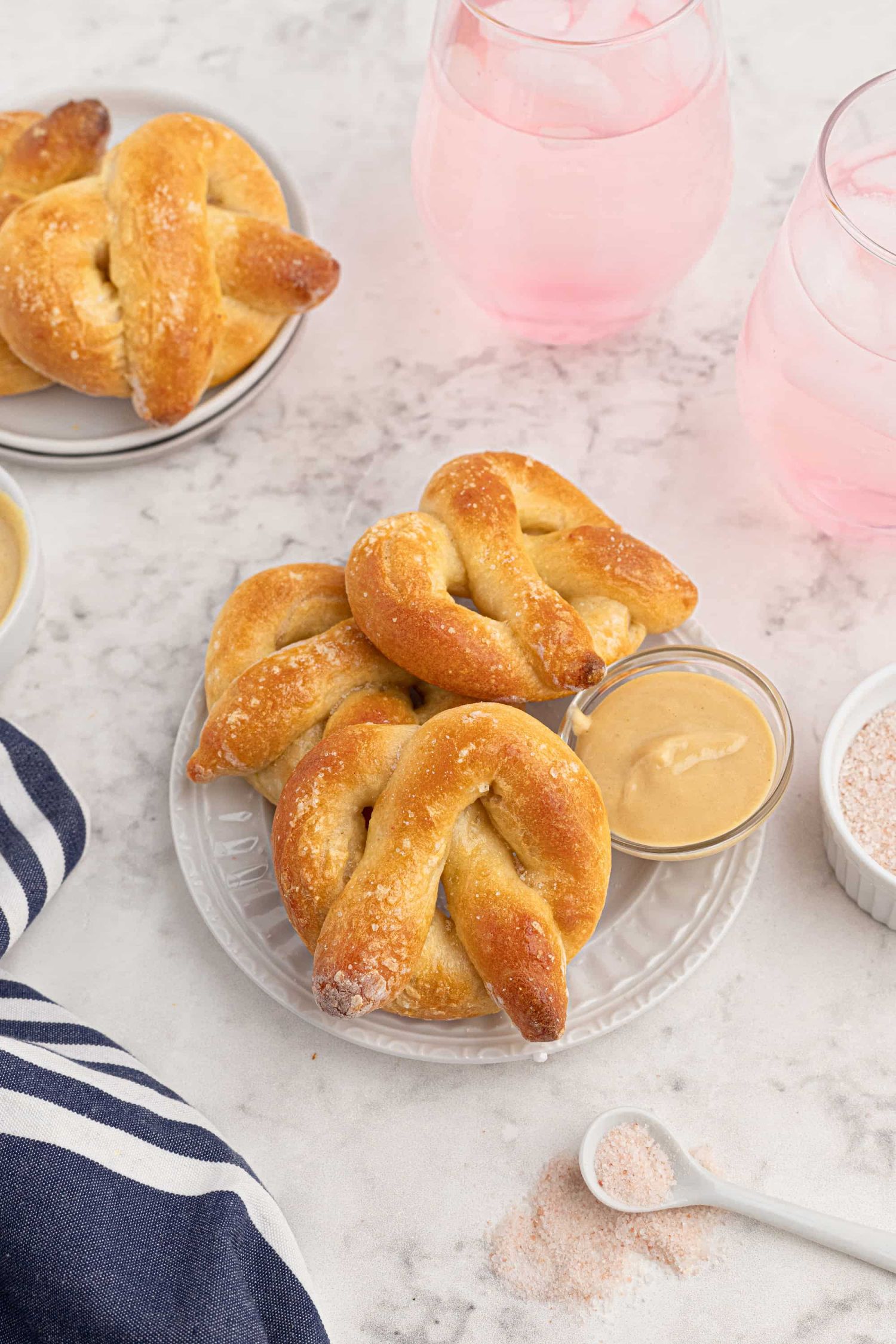 Two ingredient pretzels made with Greek yogurt and self rising flour on a plate with a blue napkin.