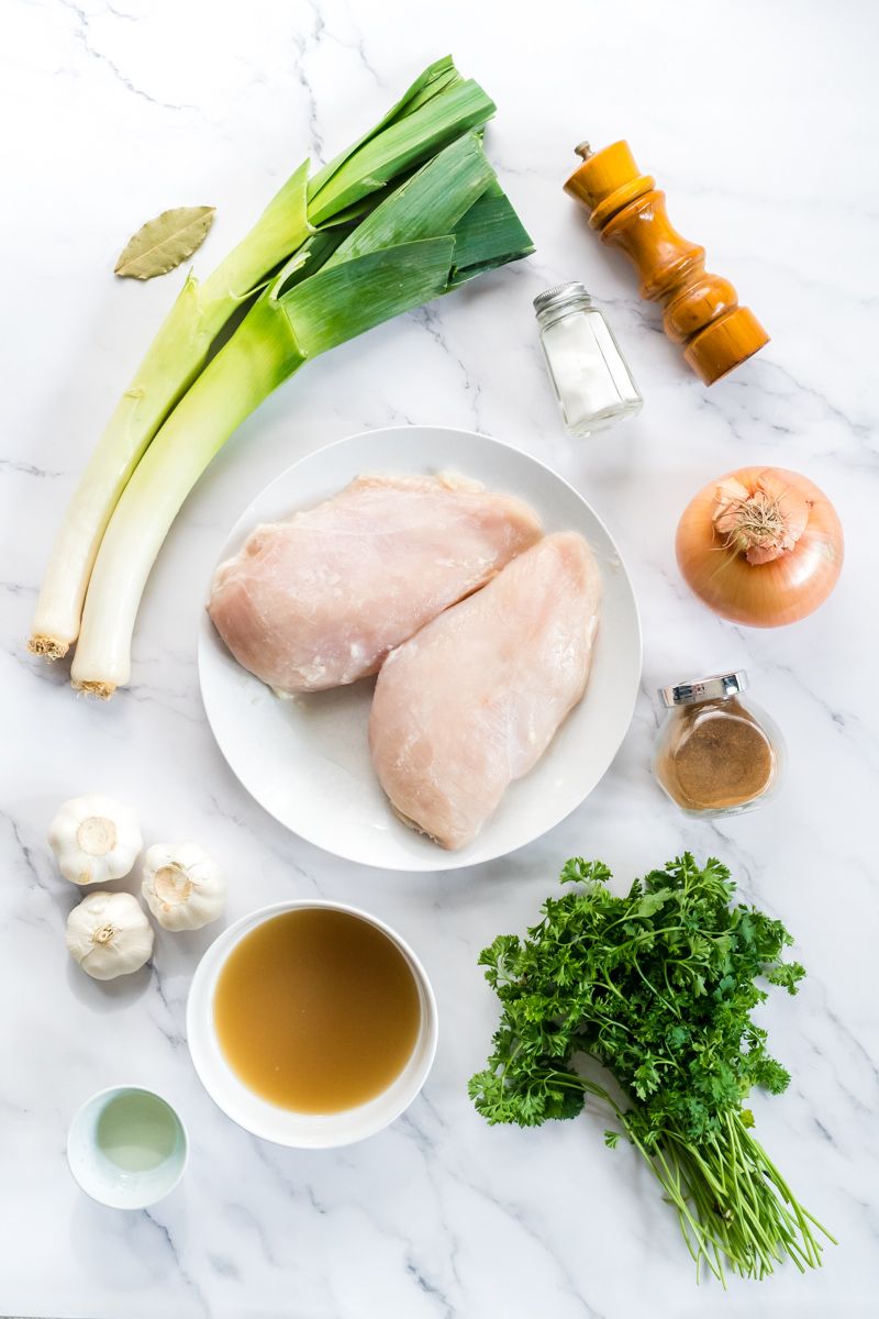 Ingredients for 40 clove of garlic chicken including chicken breast, leeks, garlic, onion, chicken broth, and parsley.