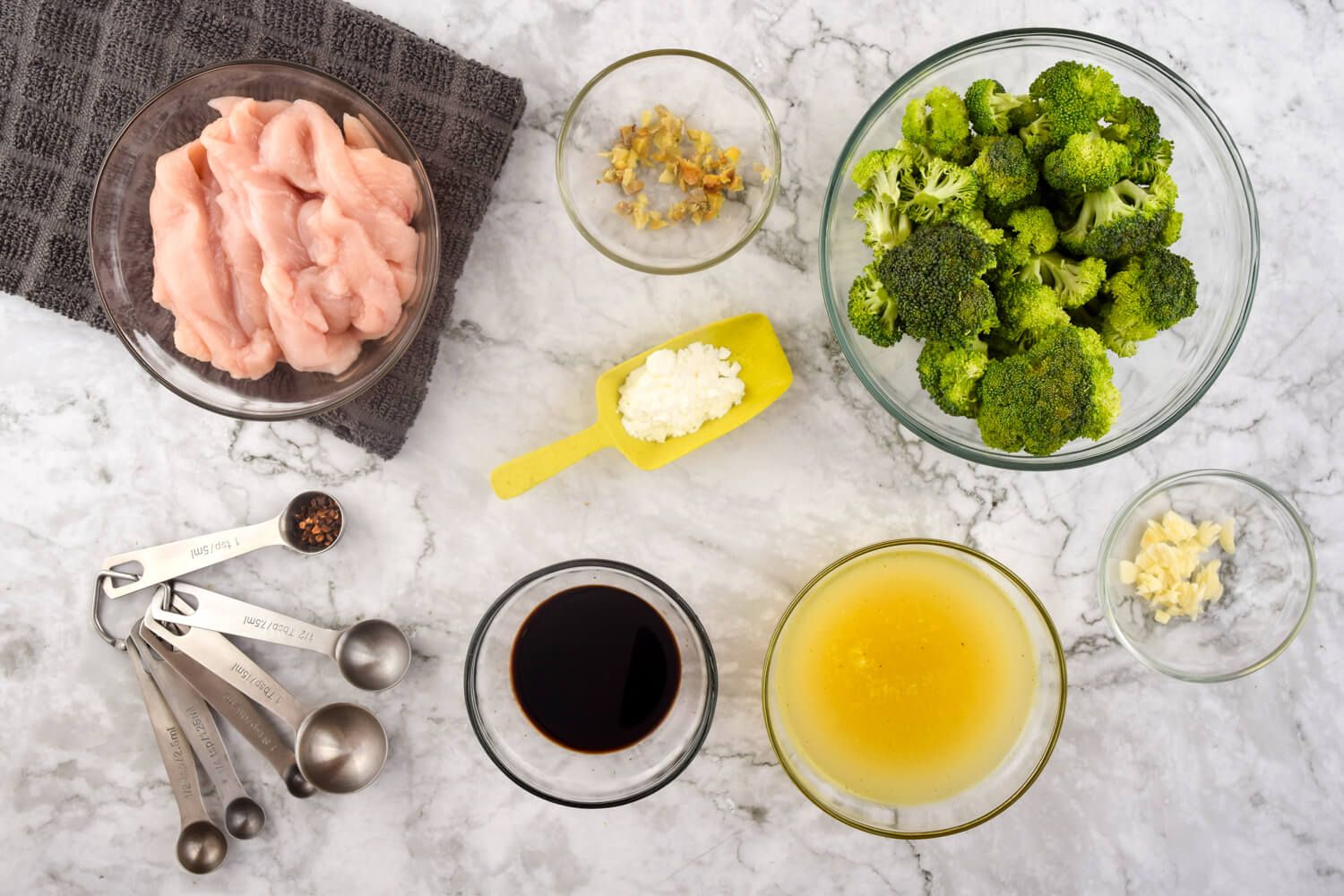 Ingredients for chicken broccoli stir fry including chicken, soy sauce, ginger, and garlic.