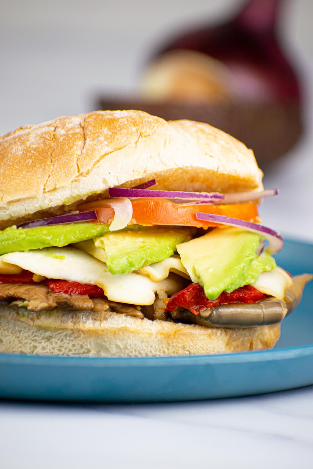 Portobello burger with roasted red peppers, mozzarella, and avocado.