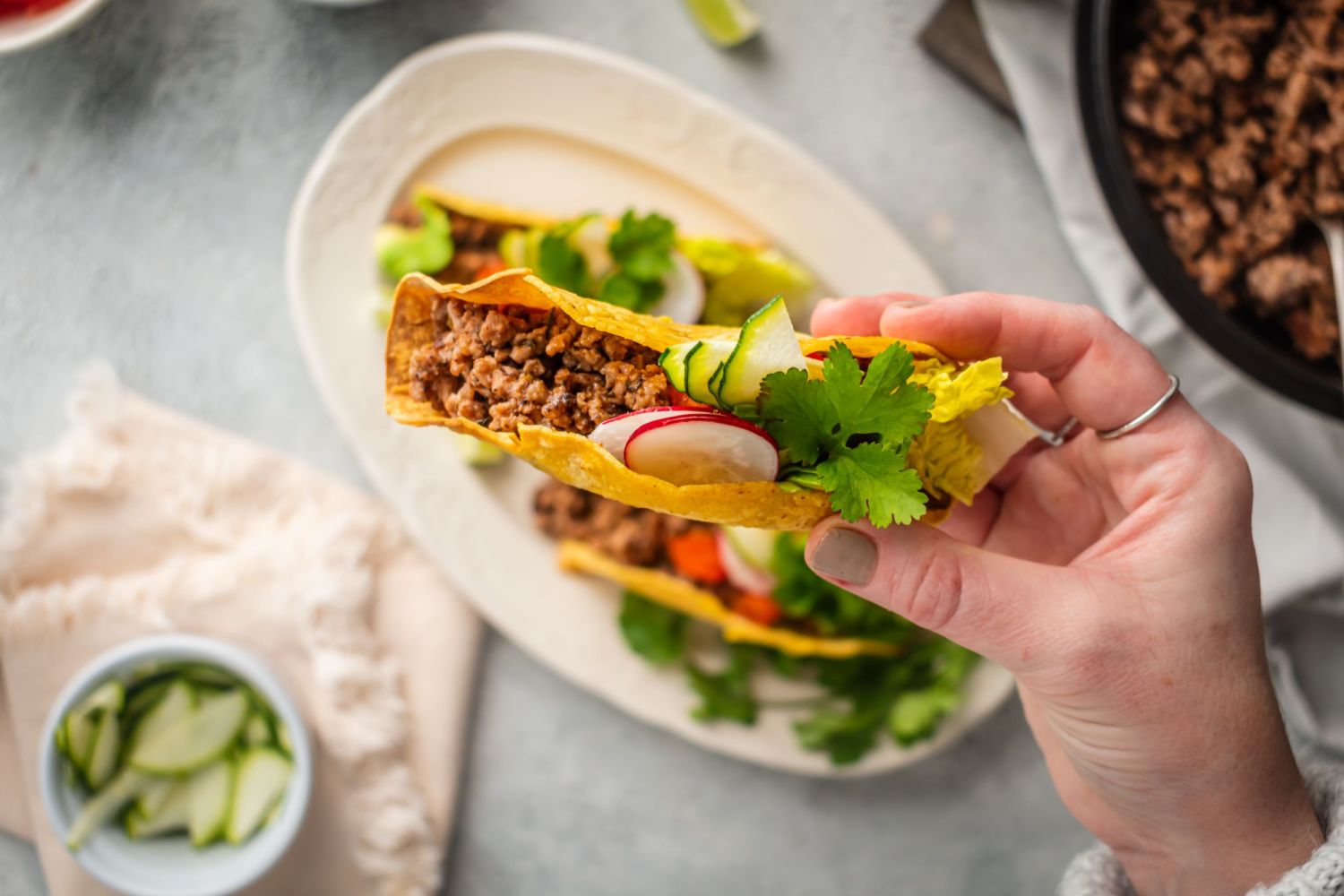 Ancho beef tacos with ground beef served in a crispy yellow corn tortilla with toppings.