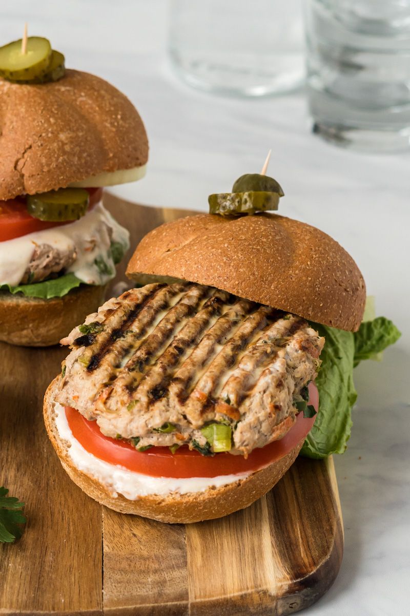 Turkey burgers with Asian flavors including garlic, ginger, and scallions grilled on a bun with sweet chili sauce.