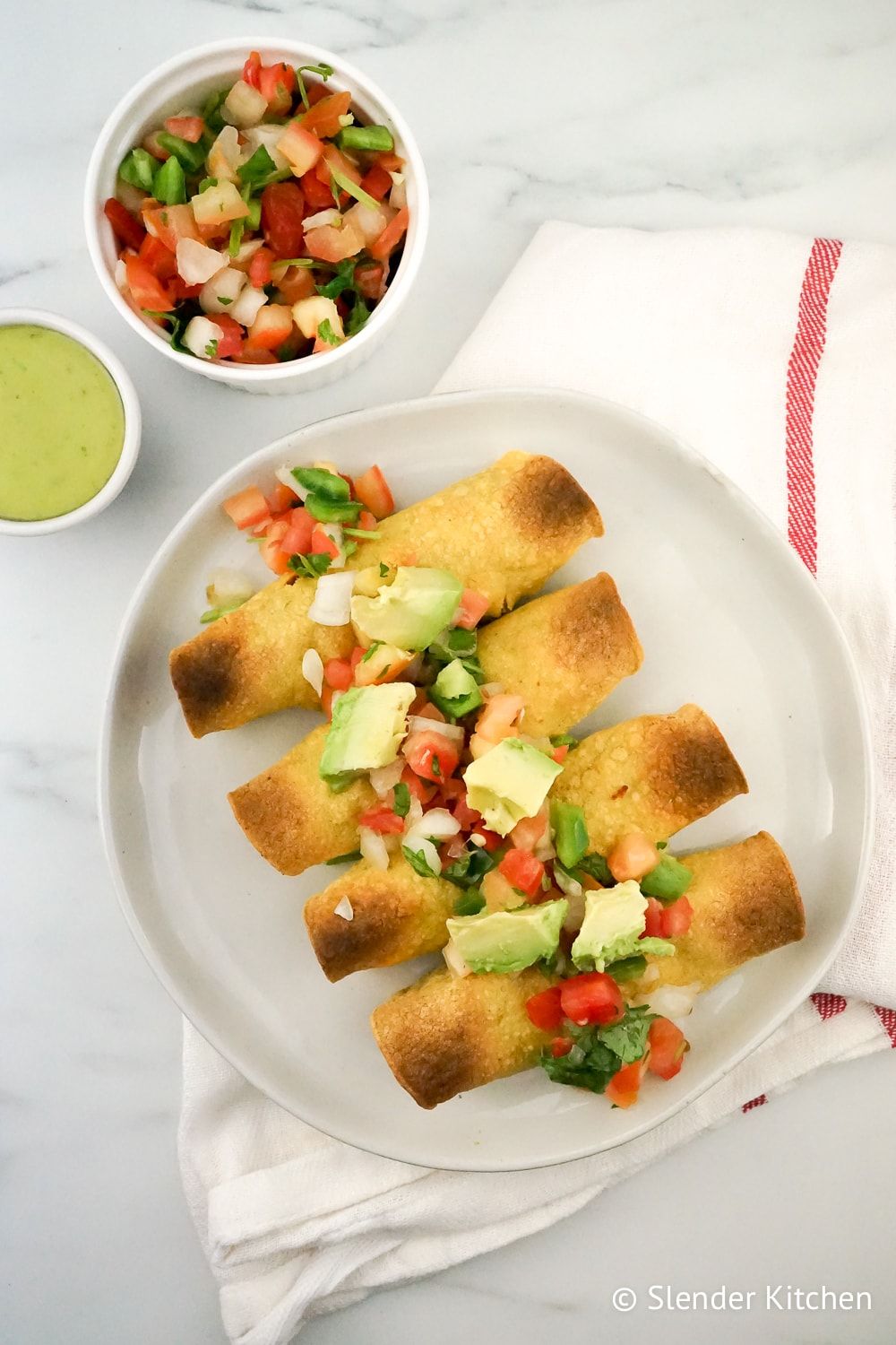 Baked Chicken and Bean Taquitos with pico de gallo and avocado.