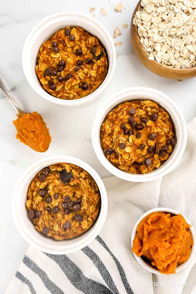 Baked pumpkin oatmeal with chocolate chips in white baking dishes.