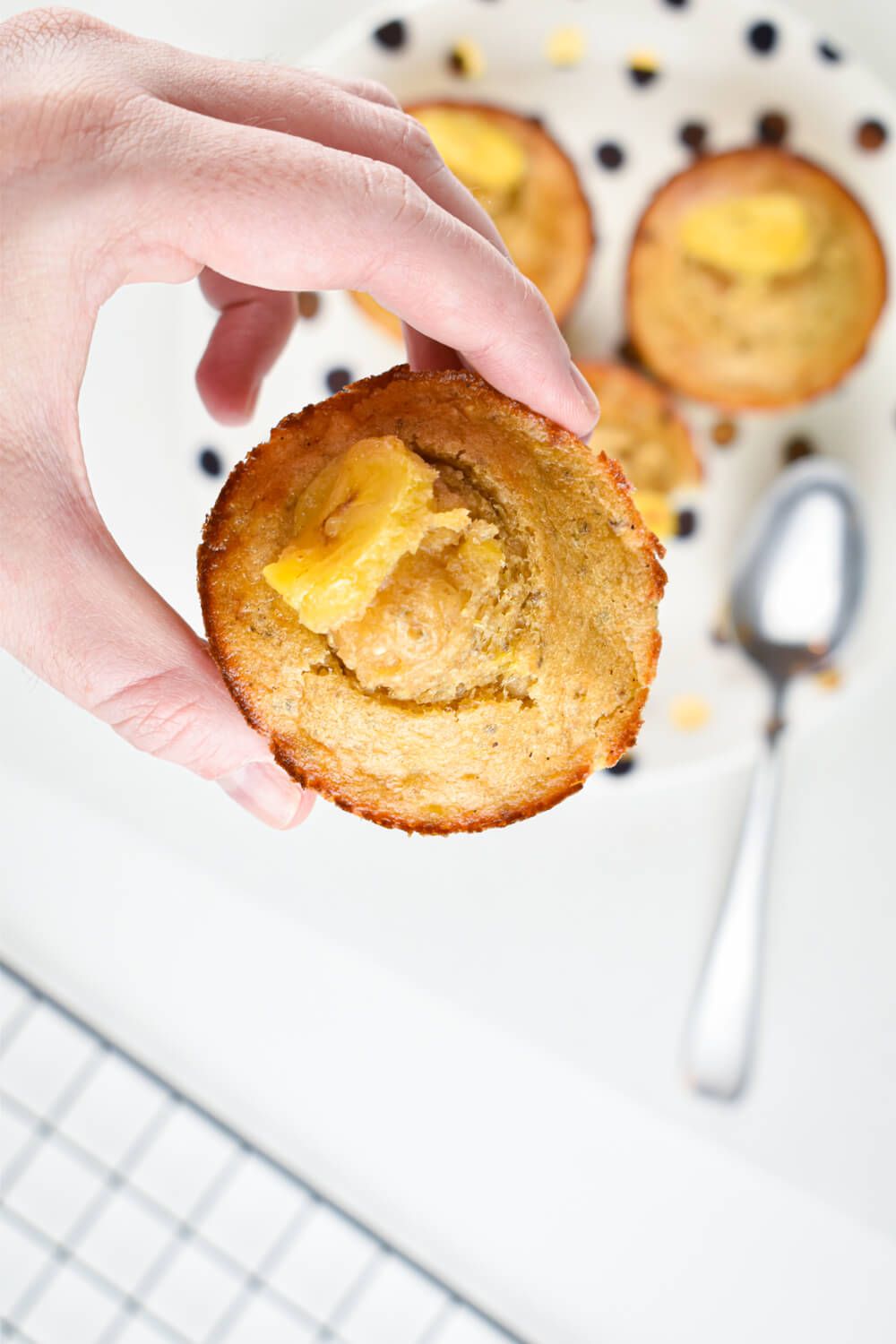 Banana chia muffins being picked up with banana, quinoa, and chia seeds.