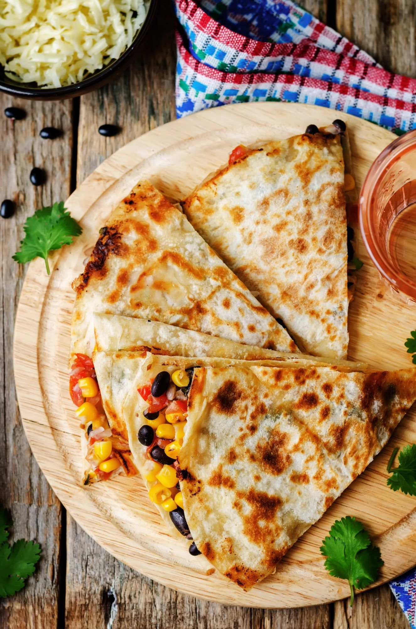 Black Bean and Corn Quesadilla on a wooden cutting board with salsa.