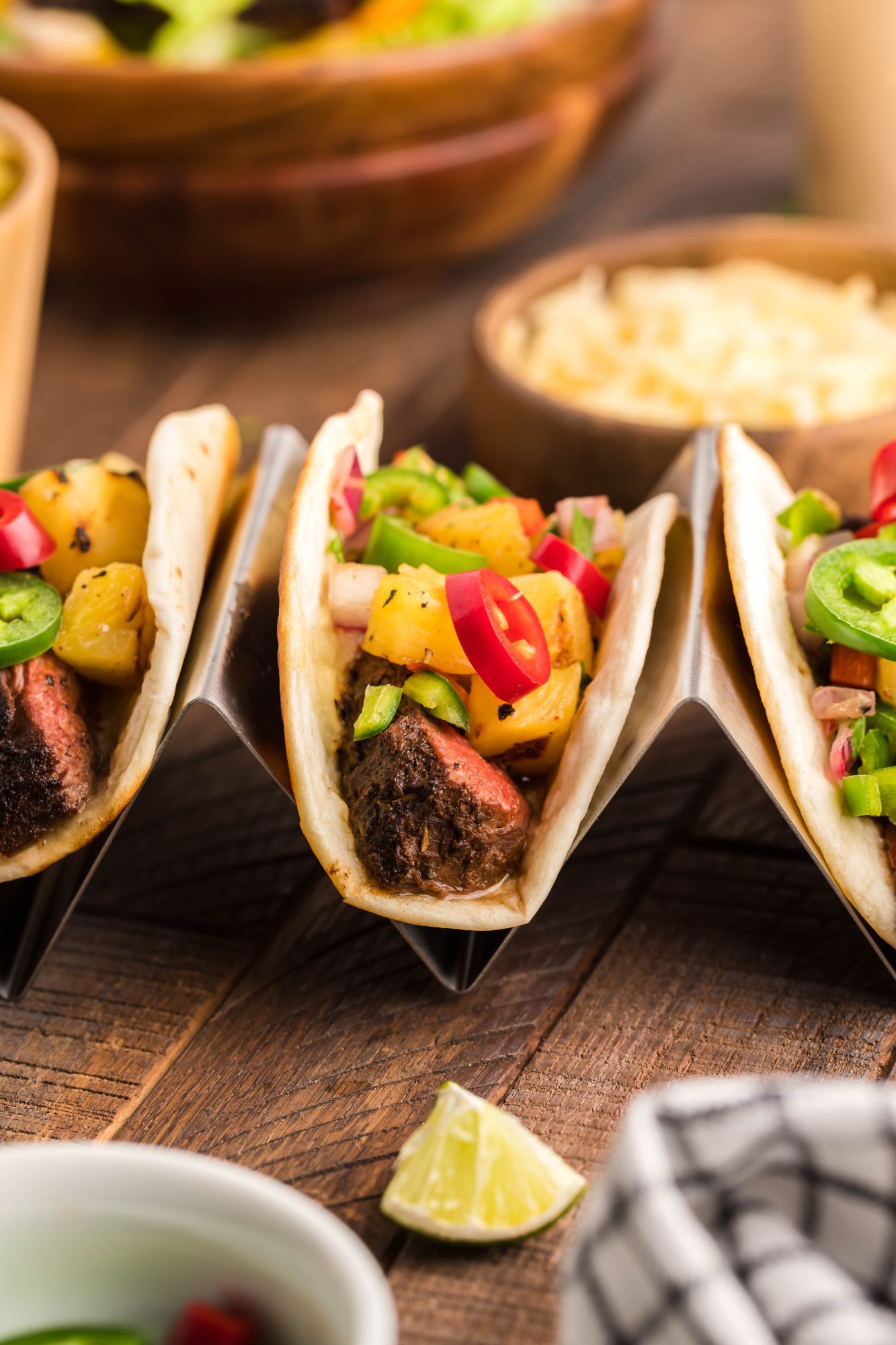 Steak tacos with blackening seasoning served in flour tortillas with pineapple salsa.