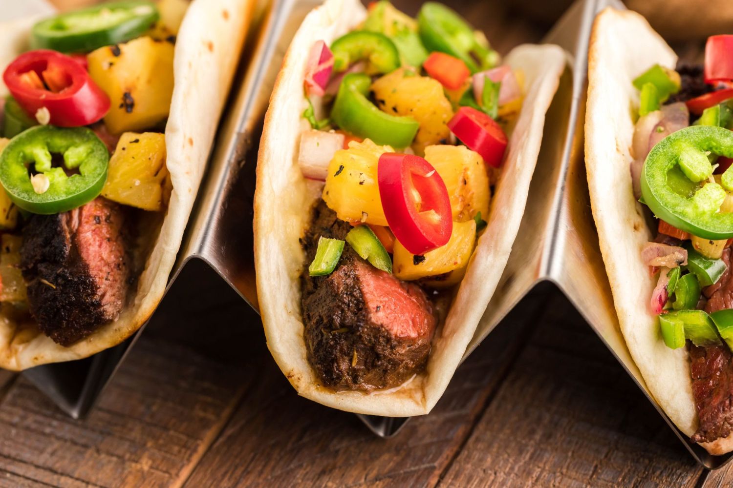 Tacos with blacked steak, pineapple salsa, jalapenos, and cilantro served in flour tortillas.