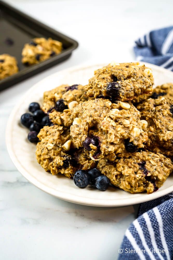 Oatmeal breakfast cookies with blueberries, bananas, chia seeds, and white chocolate chips on a plate.