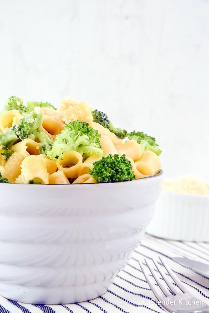 Creamy Broccoli pasta with Parmesan garlic sauce in a white bowl.