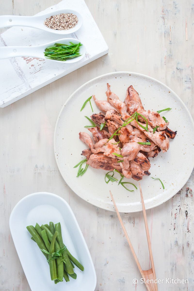 Asian chicken thighs with sesame seeds and green onions.