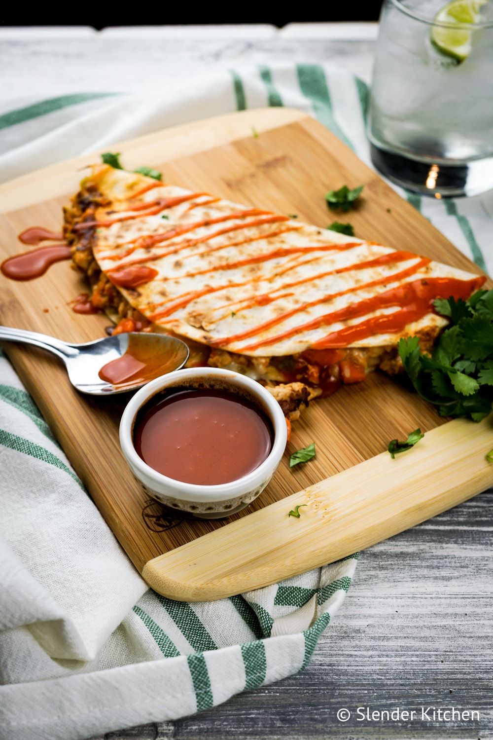 Buffalo Chicken Quesadillas on a cutting board with blurred background.