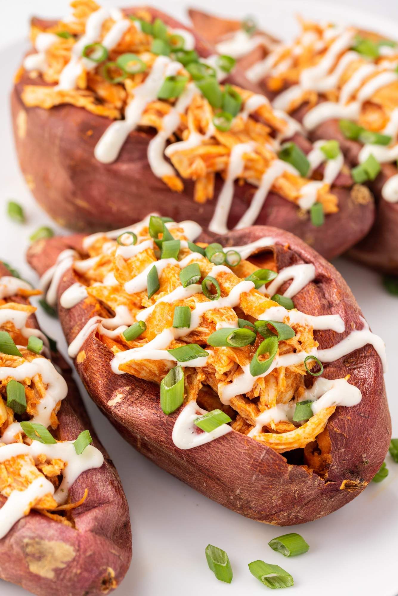 Sweet potatoes stuffed with buffalo chicken, ranch dressing, and green onions. 