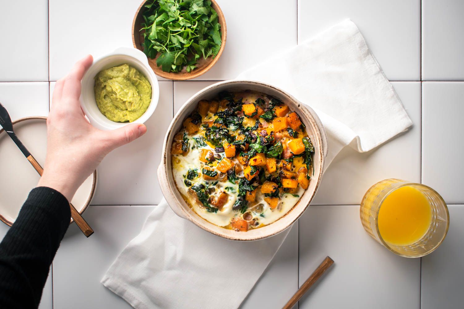 Butternut squash, spinach, and sausage egg casserole with greens and avocado on the side.