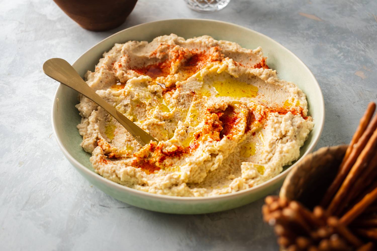 Low carb cauliflower hummus served with paprika and olive oil.