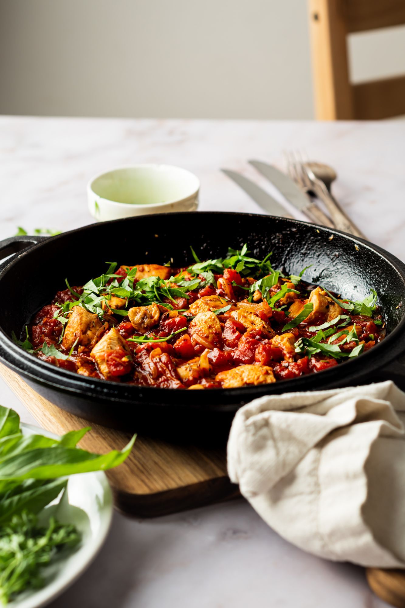 Skillet with chicken Fra Diavolo with chunks of chicken breast in spicy tomato sauce with herbs.