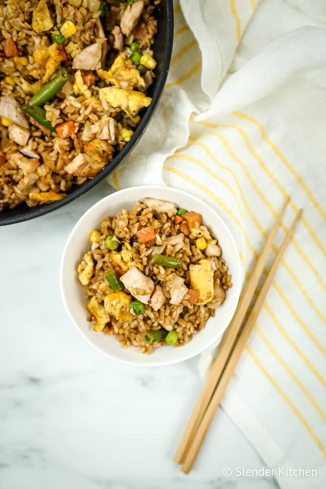 Easy chicken fried rice in a bowl with chopsticks.