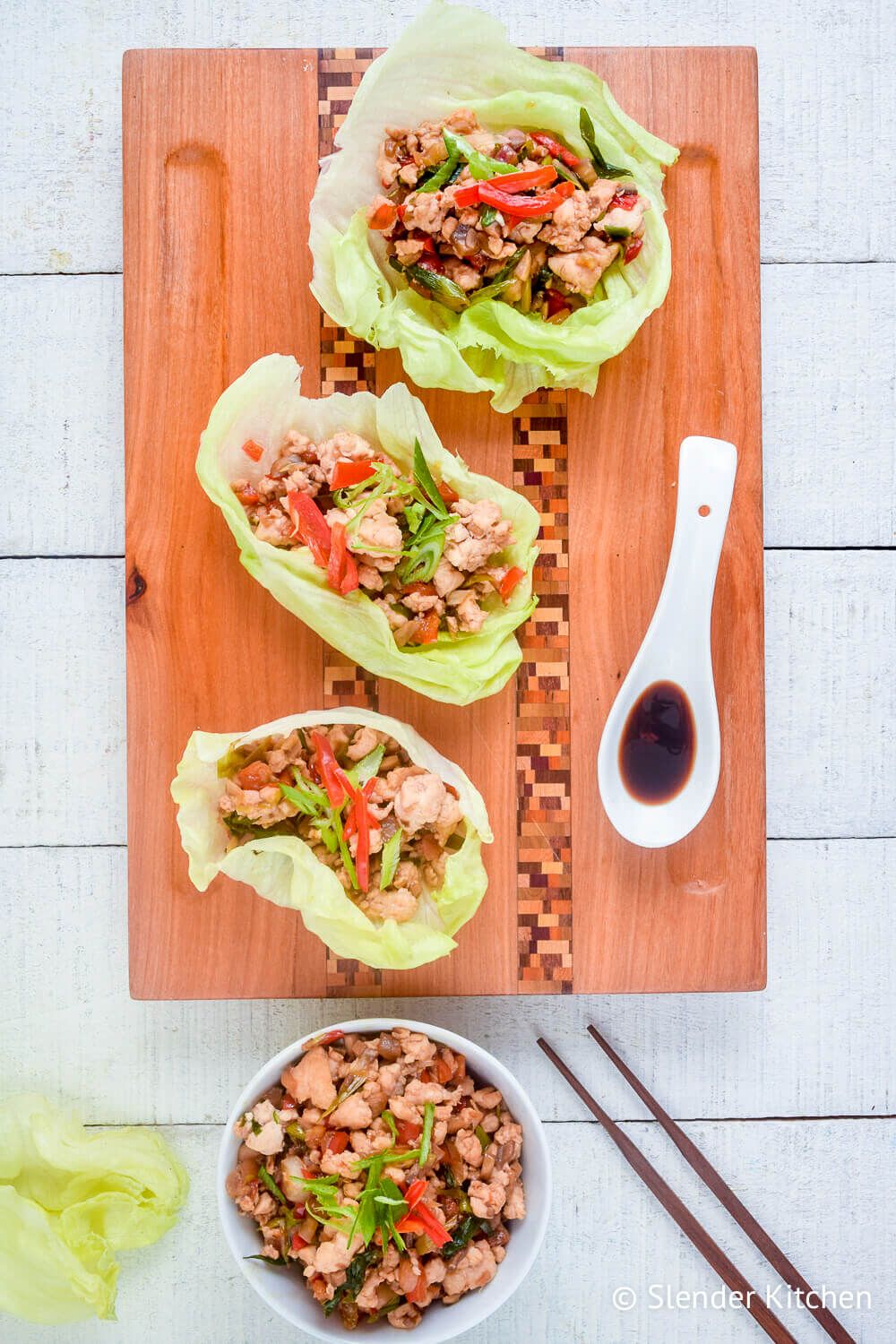 Three healthy chicken lettuce wraps with ground chicken wrapped in butter lettuce.