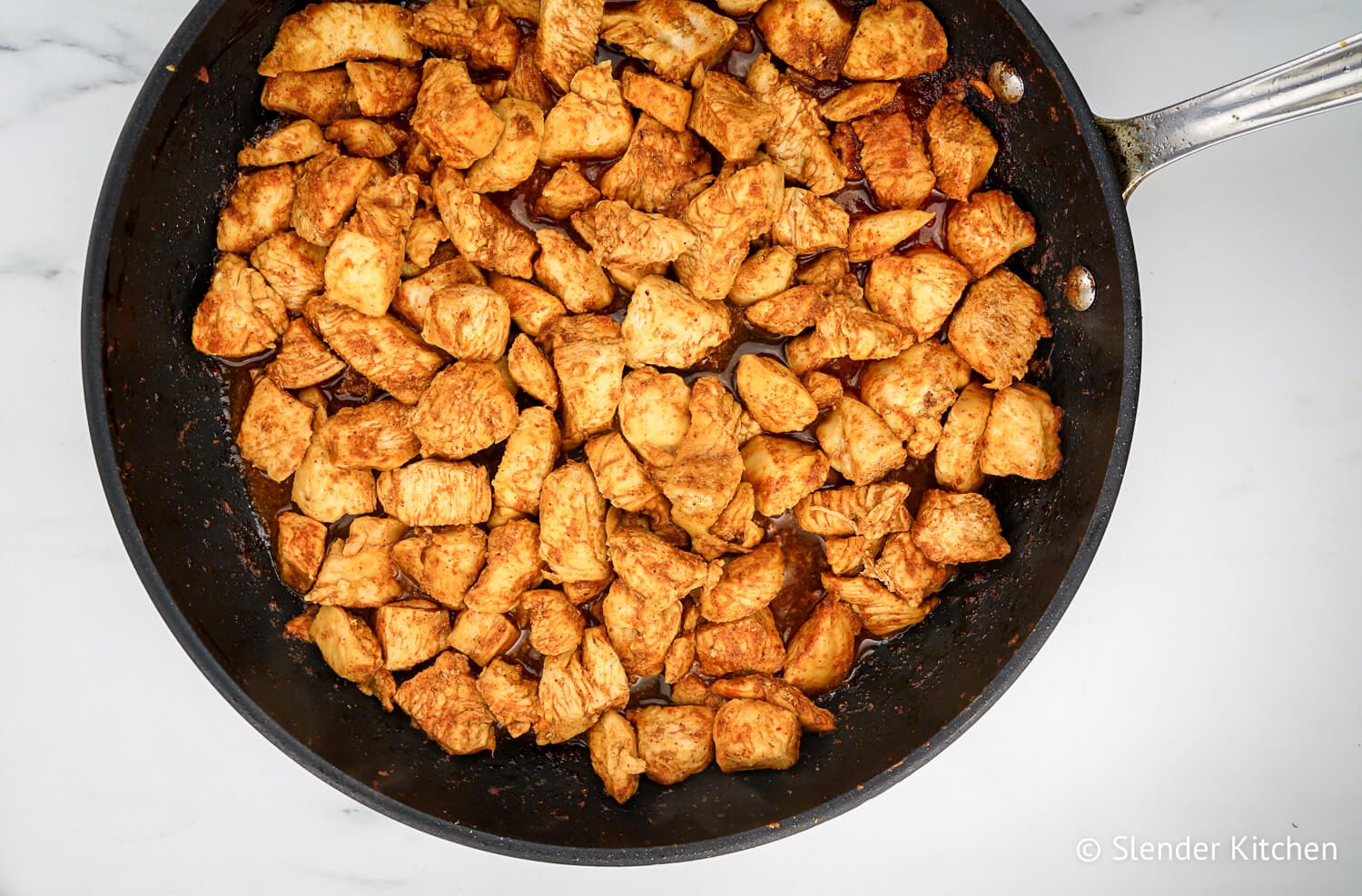 Chicken soft taco meat in a black skillet.