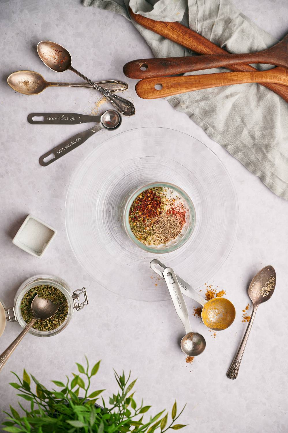 Homemade chicken taco seasoning ingredients including kosher salt, garlic powder, onion powder, chili powder, oregano, and red pepper flakes.