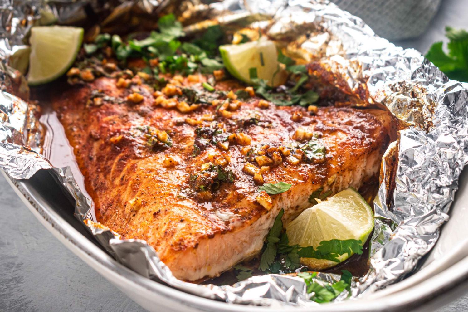 Cilantro salmon with a honey lime sauce wrapped in foil with garlic.