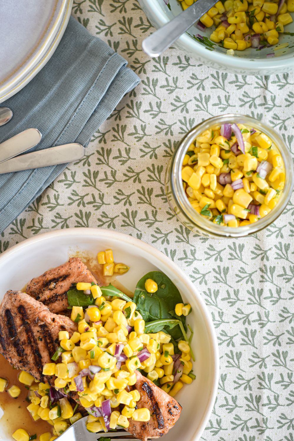 Salsa with corn, cilantro, onion, and lime juice served over grilled salmon.