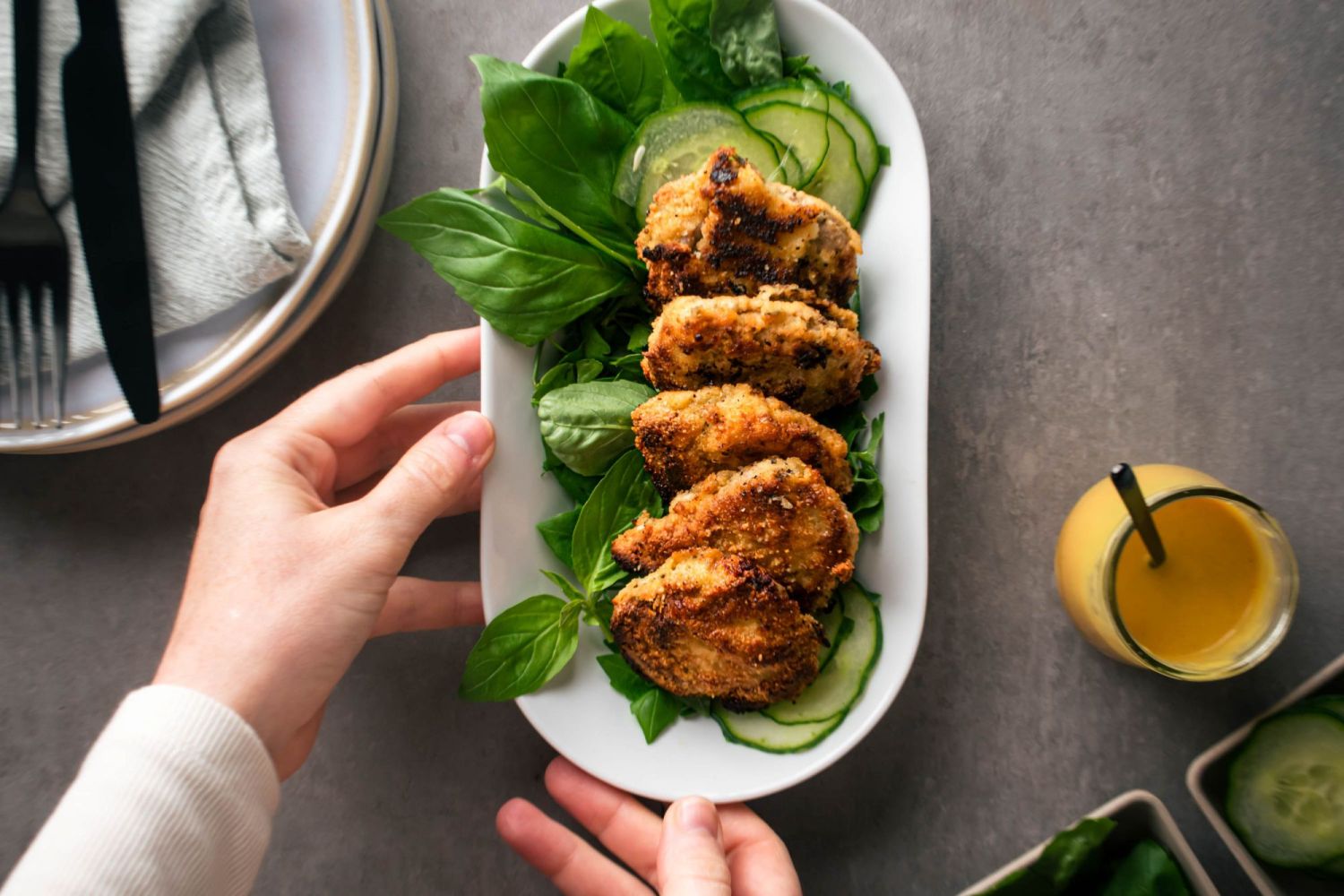 Keto almond pork chops with an egg and almond meal coating fried and served with lettuce and mustard sauce.