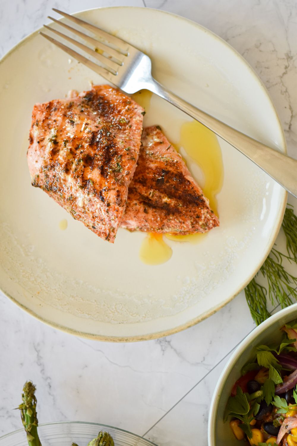 Salmon on the grill with a spice rub with asparagus and a corn salad.