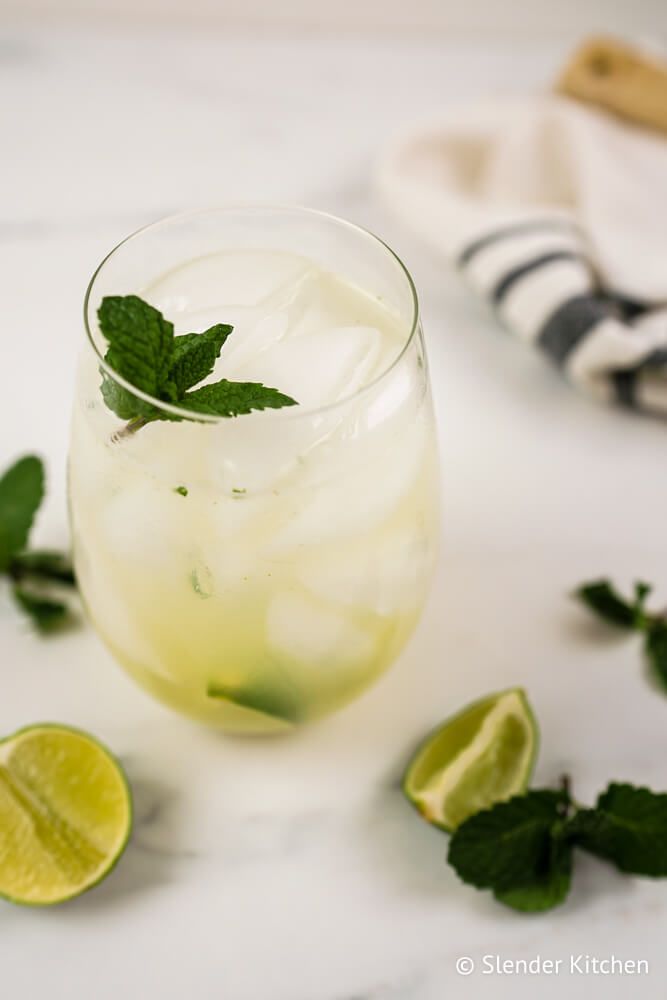 Easy Mojito in a glass with lime juice, fresh mint, white rum, and club soda.