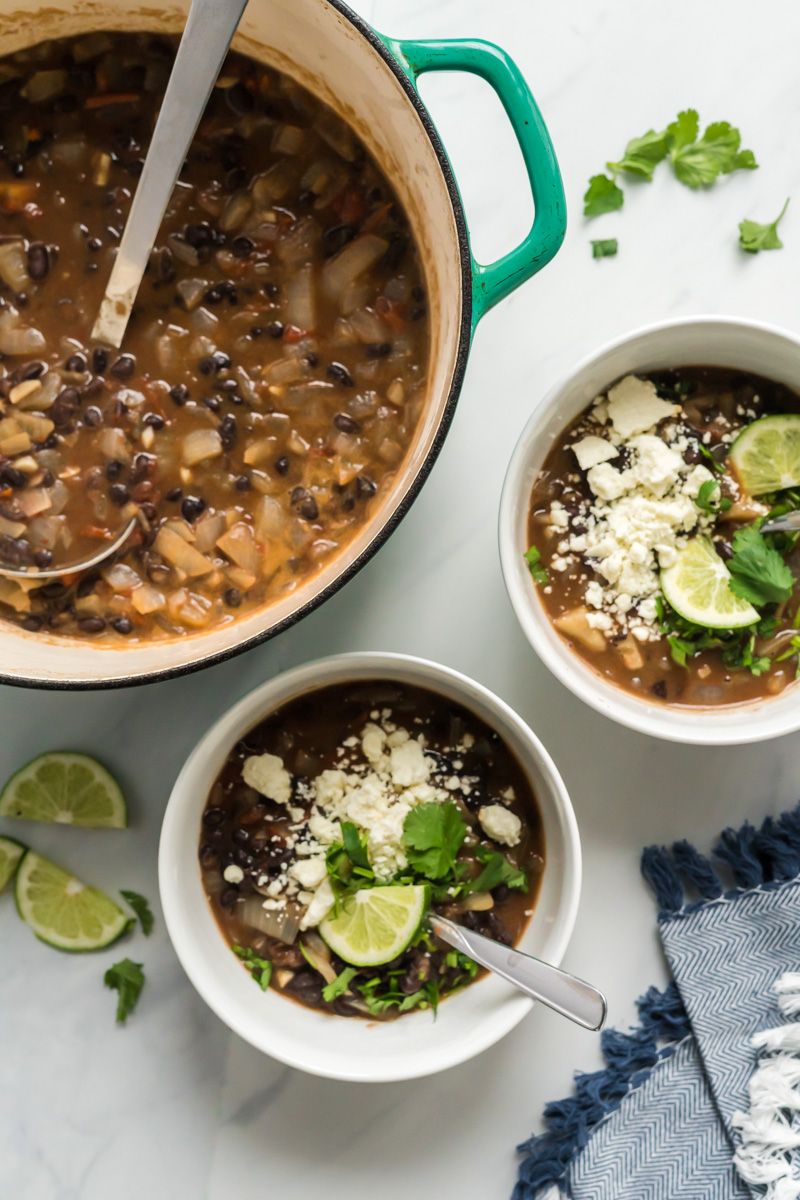 Quick and easy black bean soup with tomatoes and topped with cilantro and queso fresco.