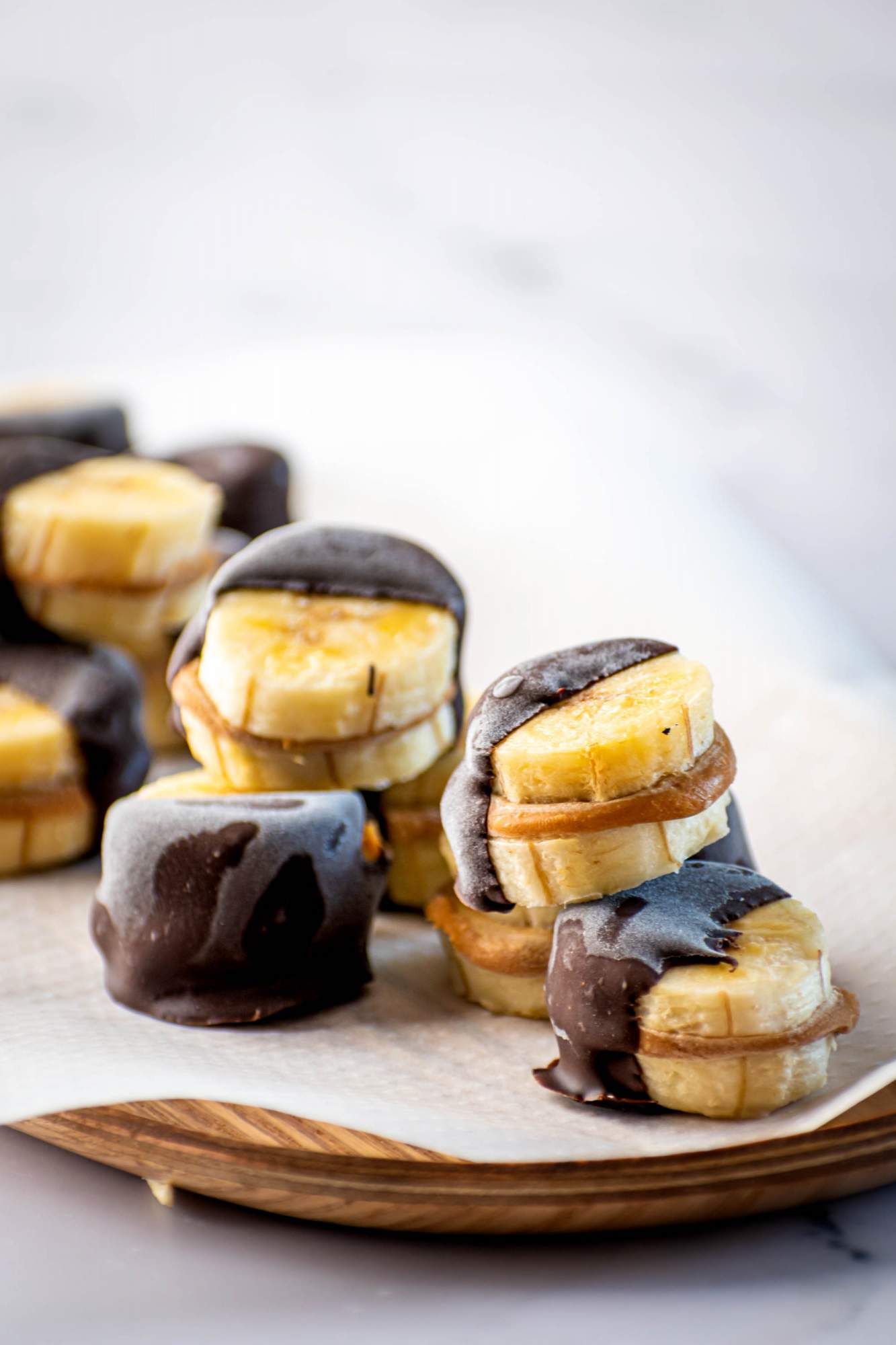 Chocolate and peanut butter banana bites frozen into sandwiches and stacked up.