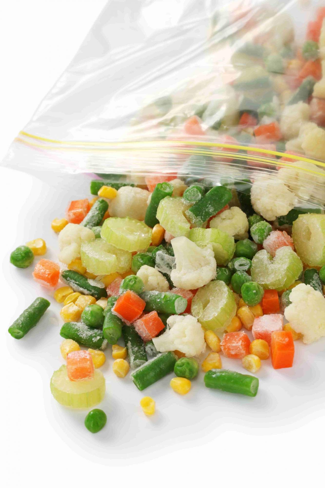 Roasted frozen vegetables including carrots, zucchini, corn, and cauliflower in aa ziploc bag.