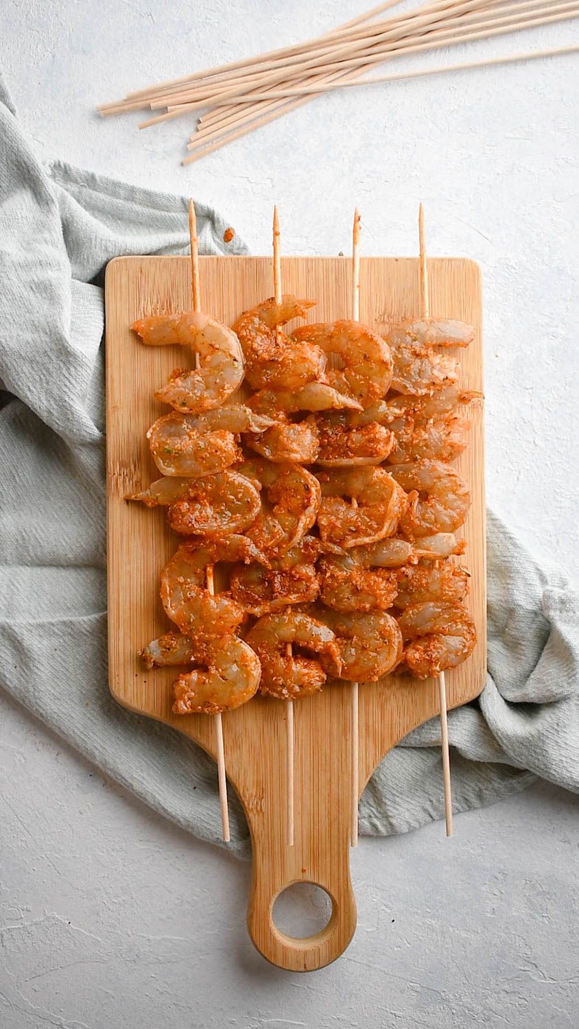 Shrimp marinated in spices and garlic and threaded on a skewer for grilling.