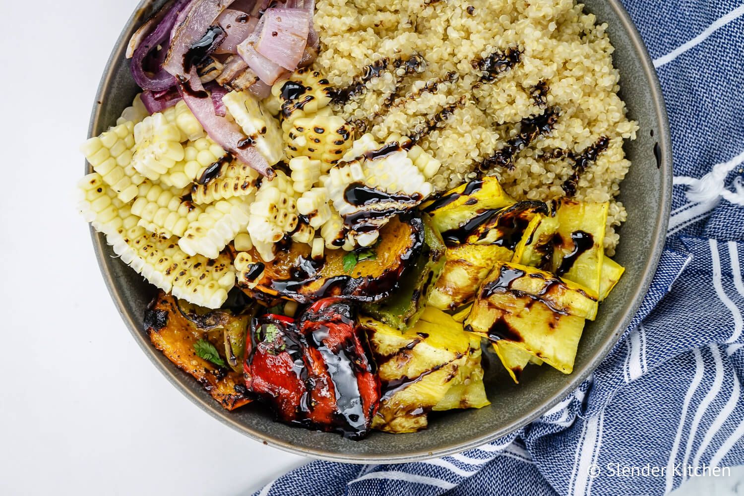 Grilling Vegetables with balsamic glaze including onions, squash, peppers, and corn with quinoa.