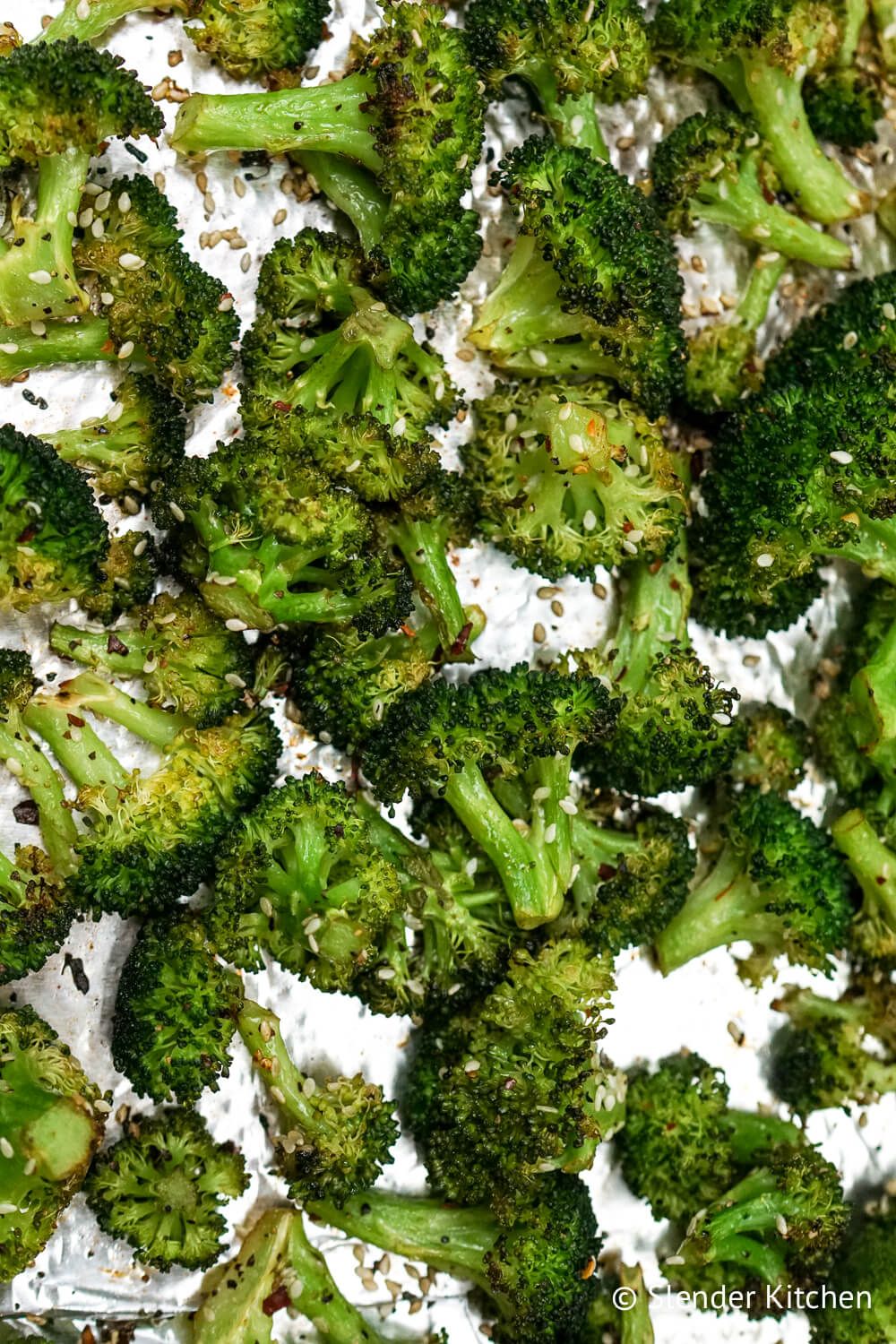 Grilling broccoli on aluminum foil with garlic.