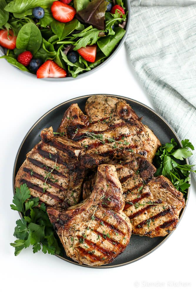 Pork chops from the grill with a strawberry and spinach salad.