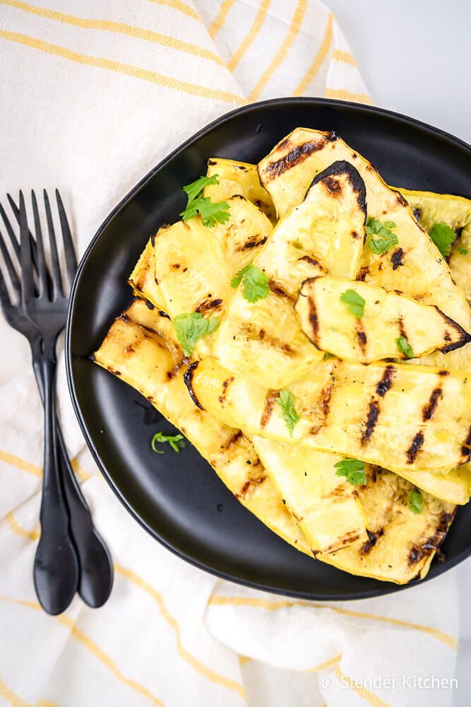 Grilled summer squash cut in planks and sprinkled with salt, pepper, and parsley.