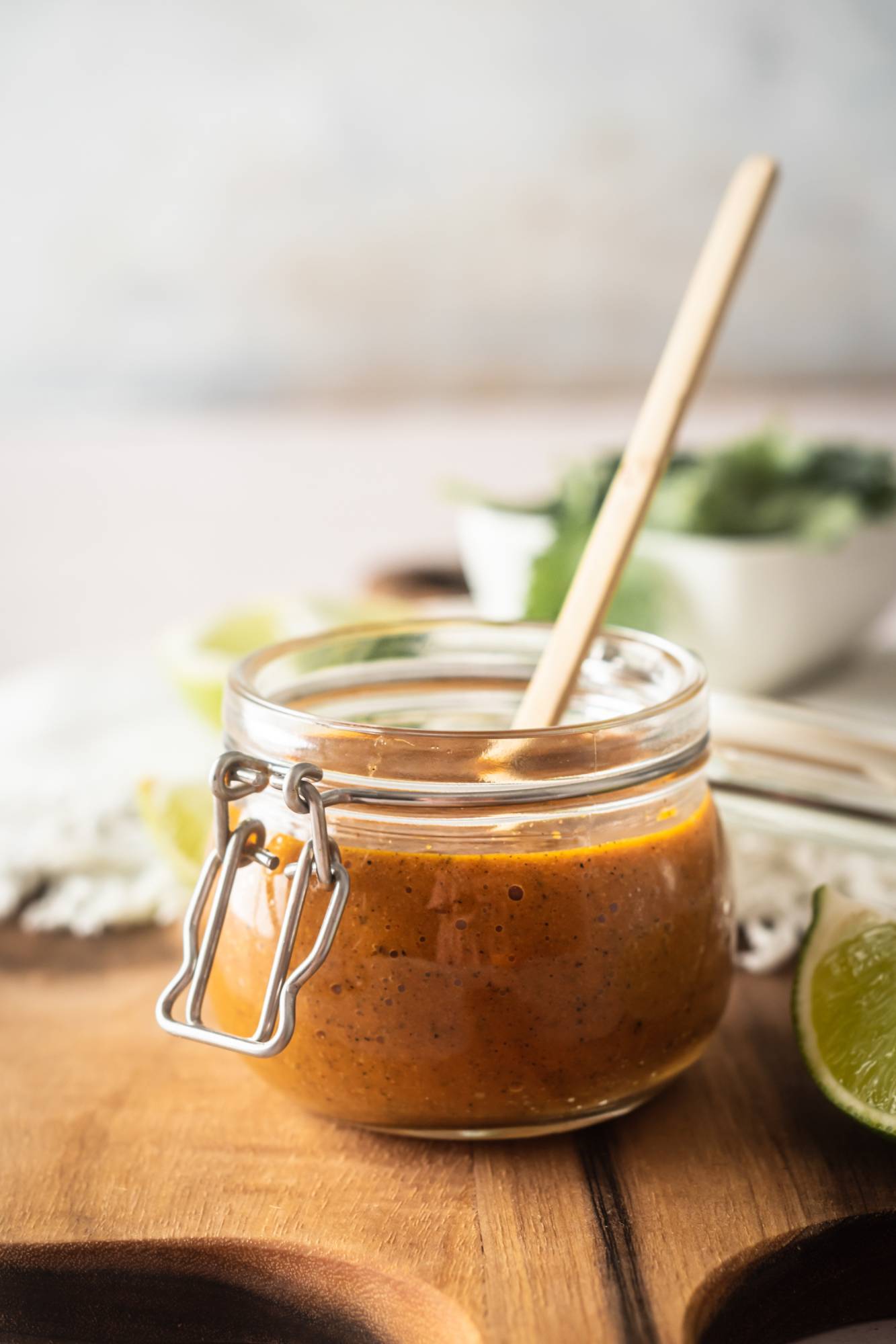 Homemade spicy habanero salsa with garlic, citrus juice, and tomatillos in a glass jar. 