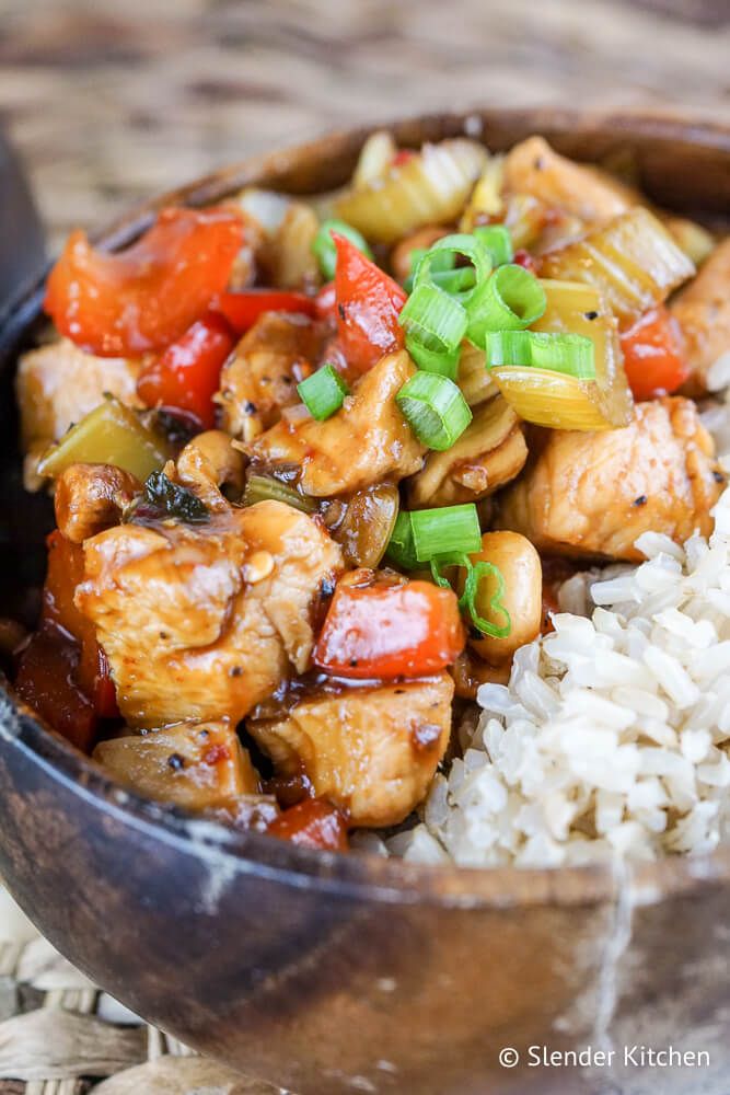 Easy Kung Pao Chicken in a bowl with peanuts and green onions.