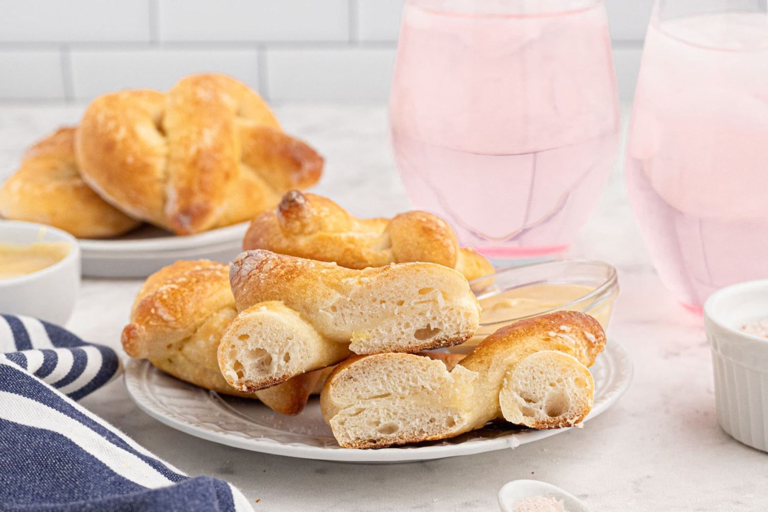 Soft pretzels that have been cut in half and served with honey mustard.