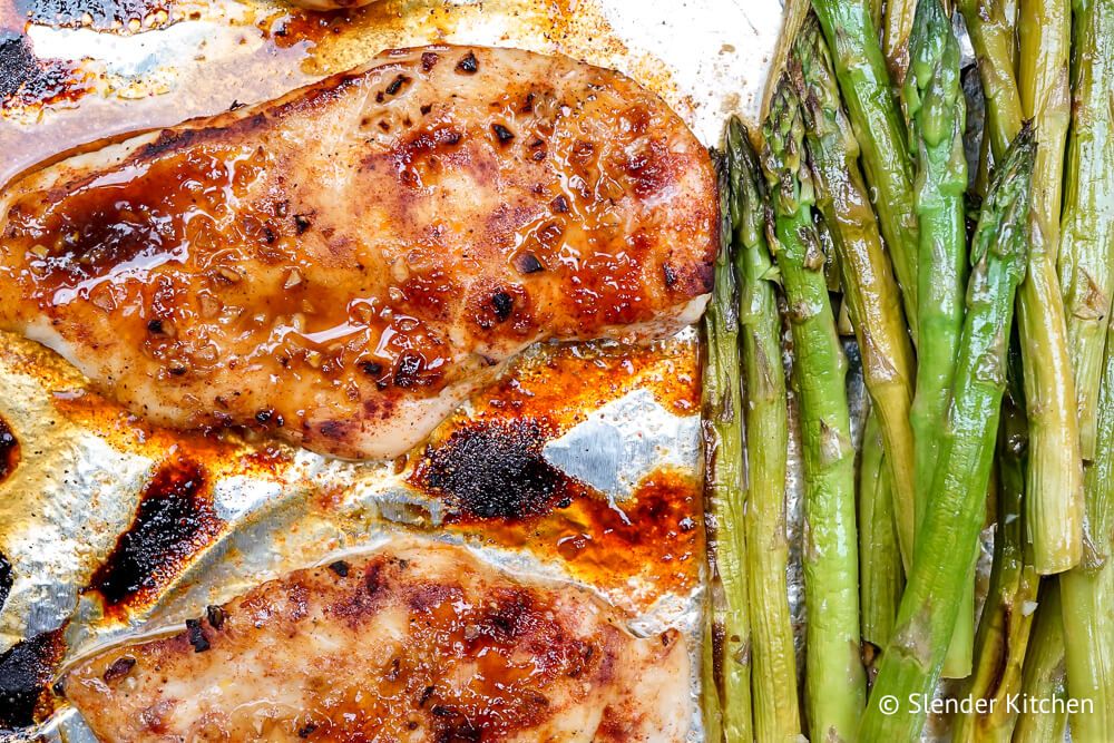 Chicken and asparagus in a honey mustard sauce on foil.