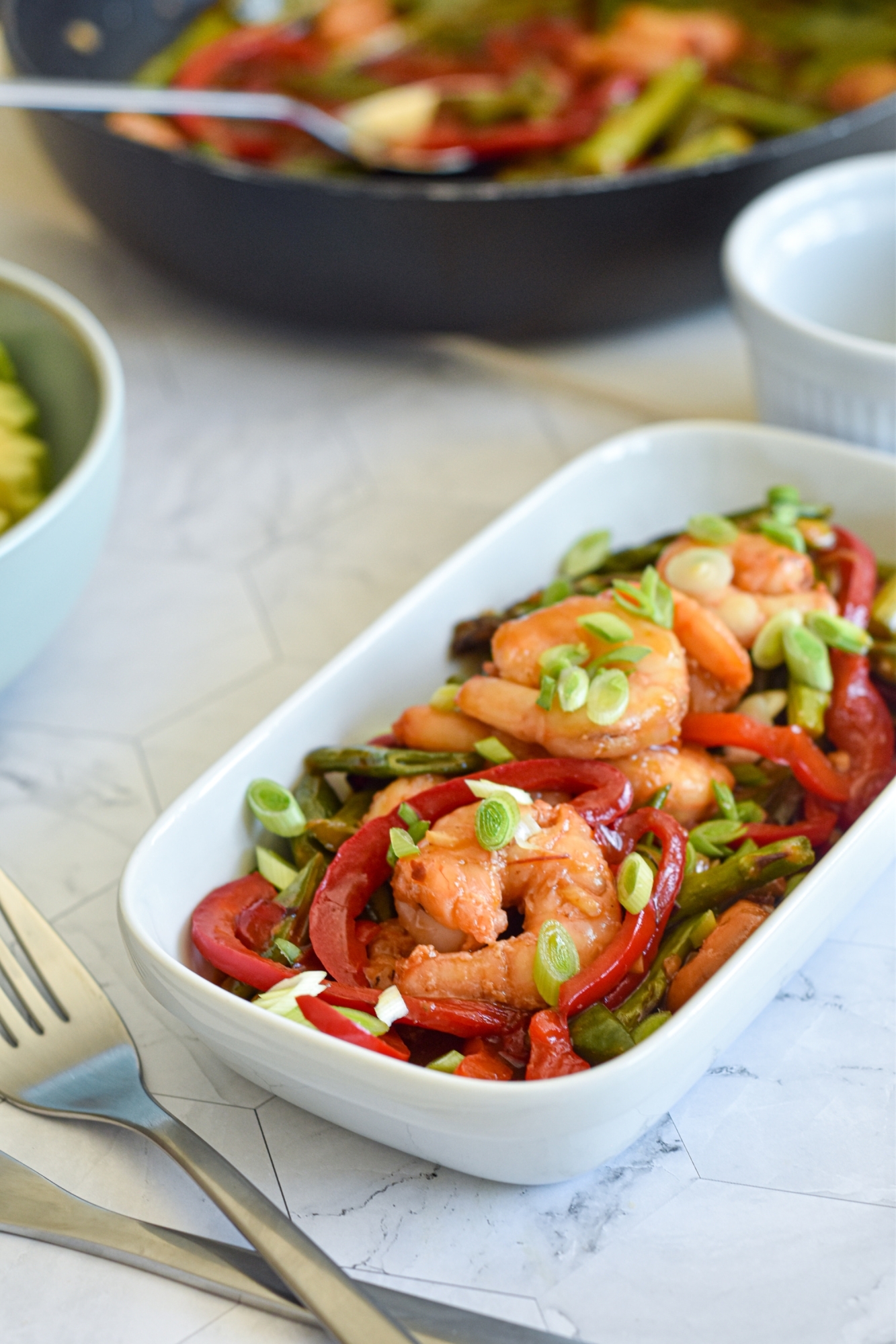 Shrimp stir fry with an orange honey garlic sauce with asparagus, snap peas, bell peppers, and green onions.