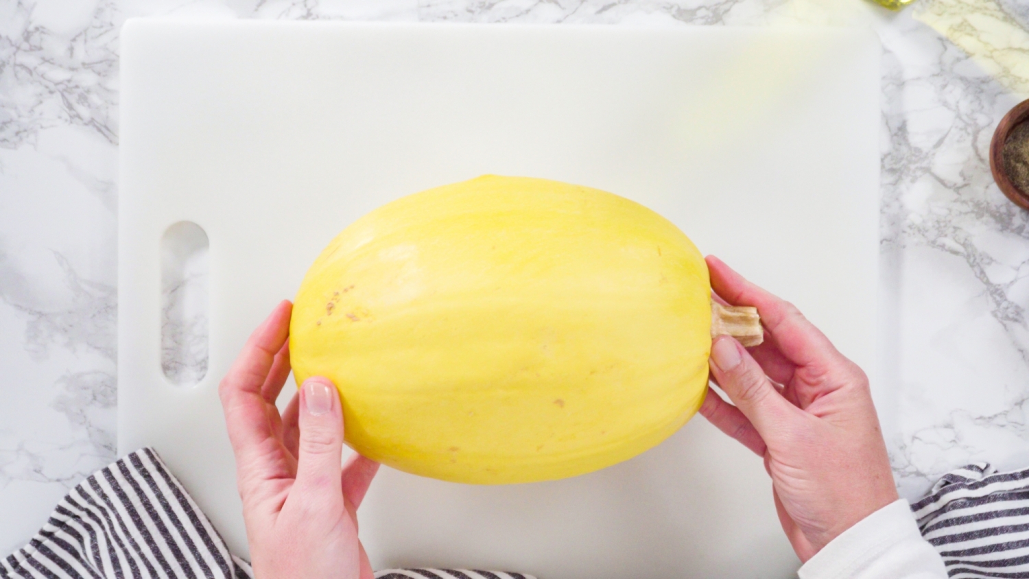 Whole spaghetti squash on a cutting board.