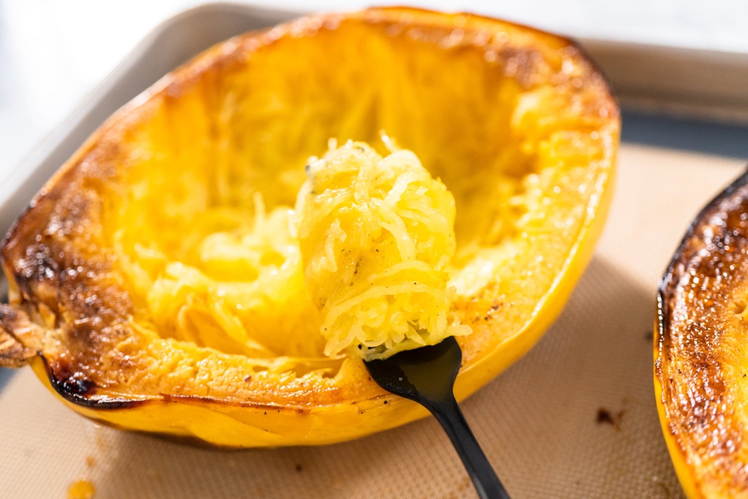 Spaghetti squash pulled into strands with a fork.