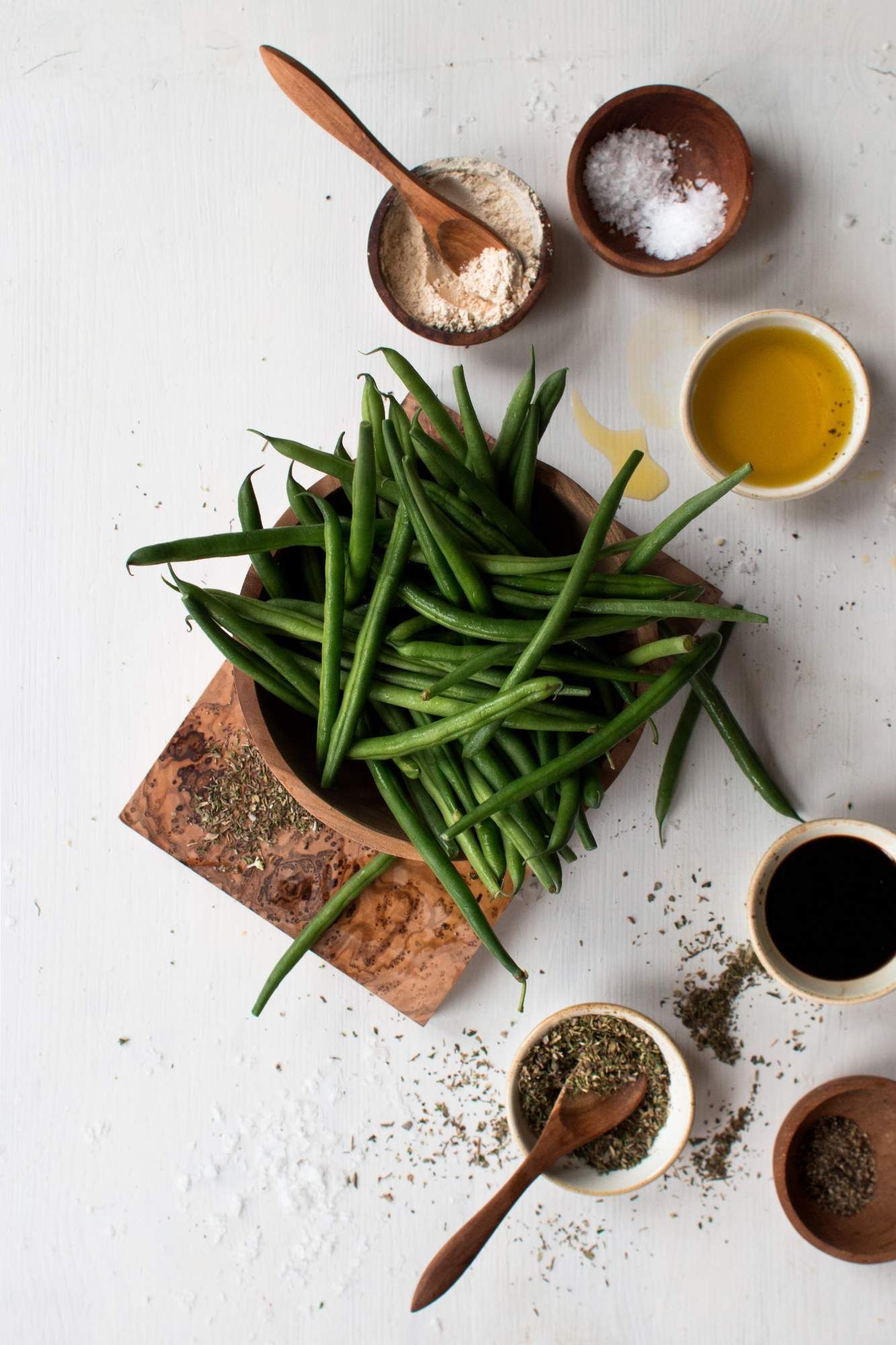 Ingredients for roasted green beans including green beans, oil, salt, pepper, and olive oil.