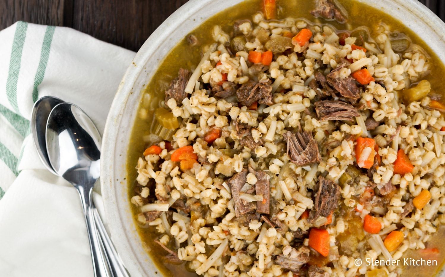 Healthy Beef and Barley Stew made in the Instant Pot in a ceramic bowl with a napkin.